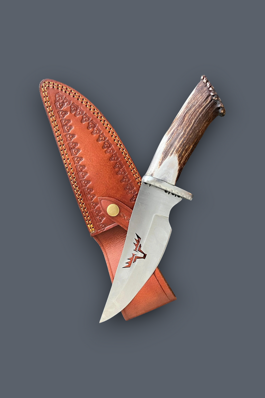 A fixed-blade knife with a silver blade and brown antler-style handle, shown crossed over a tan leather sheath on a dark gray background.