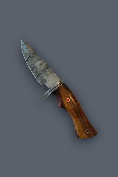 A fixed-blade knife with a patterned steel blade and a polished brown wooden handle, shown diagonally against a solid dark gray background.