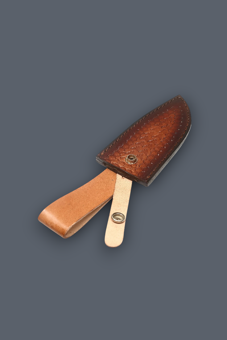 A brown textured leather knife sheath with a matching leather loop and a light tan metal pin, shown on a solid dark gray background.
