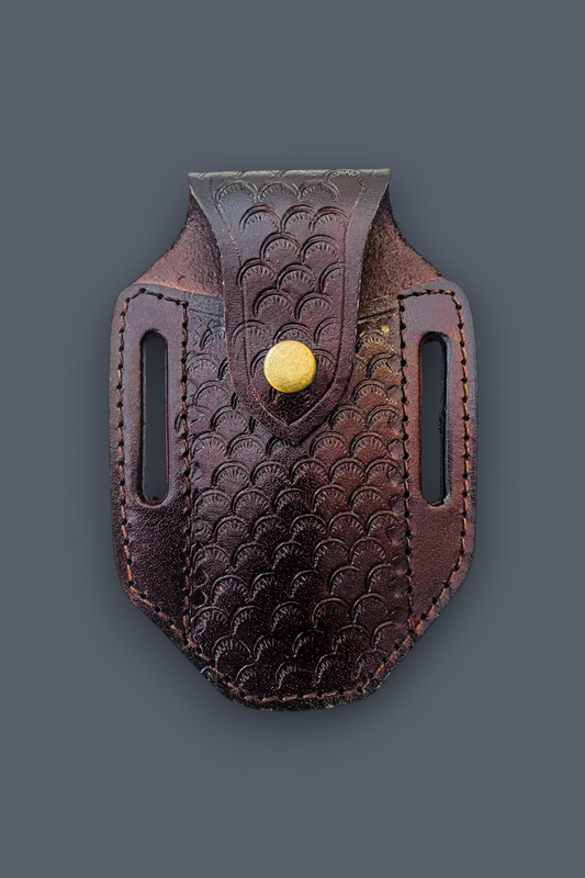A dark brown leather belt holster with a scalloped embossed pattern and a gold snap button, shown against a solid dark gray background.