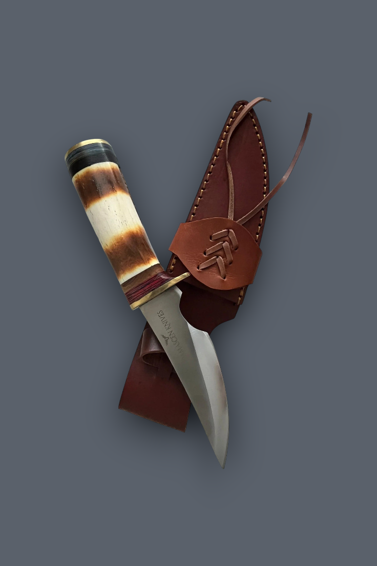 A fixed-blade knife with a curved silver blade, a brown and cream striped handle, and a brown leather sheath, arranged on a dark gray background.