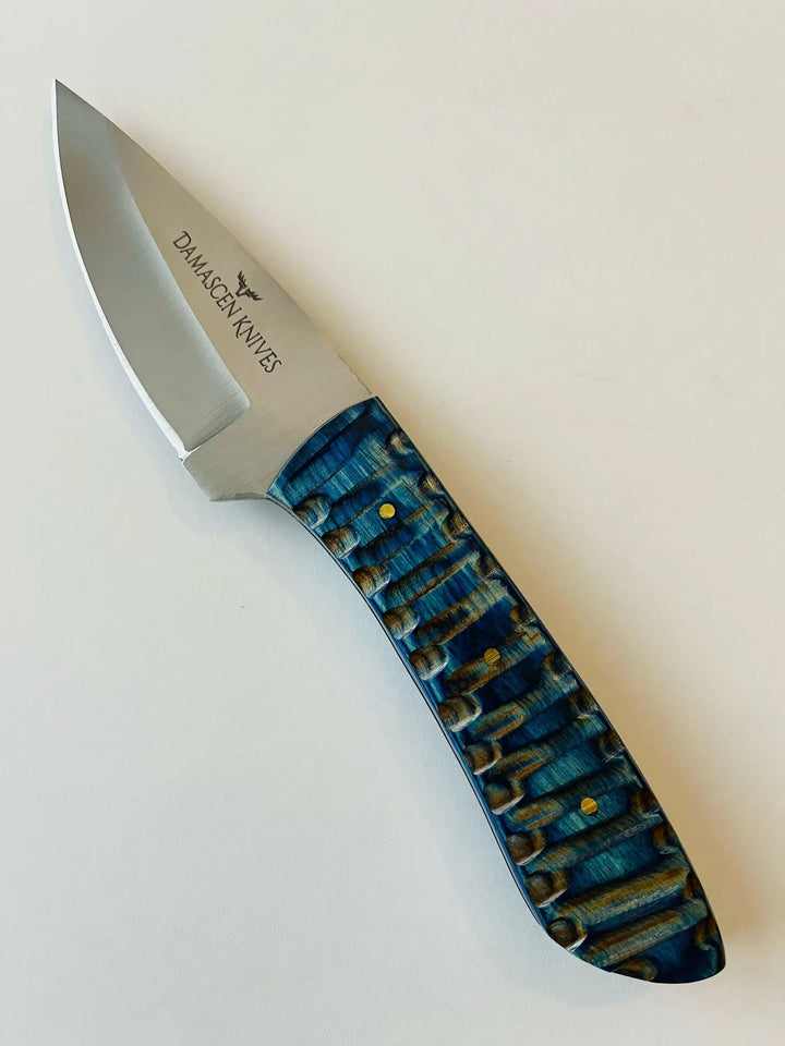 Blue Phantom knife and handmade leather sheath with bead and fringe detailing for premium protection.