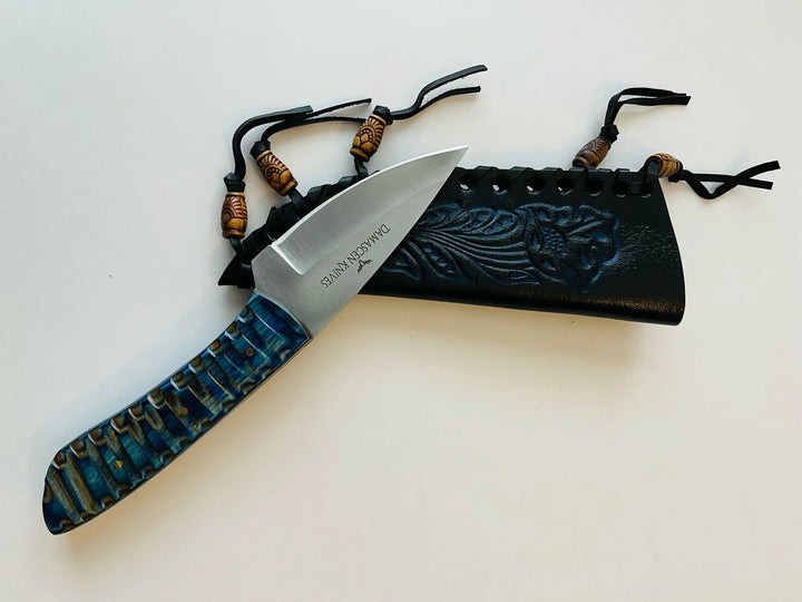Flat lay of Blue Phantom Fixed Blade Knife and leather sheath — ideal for hunting, camping, and survival.
