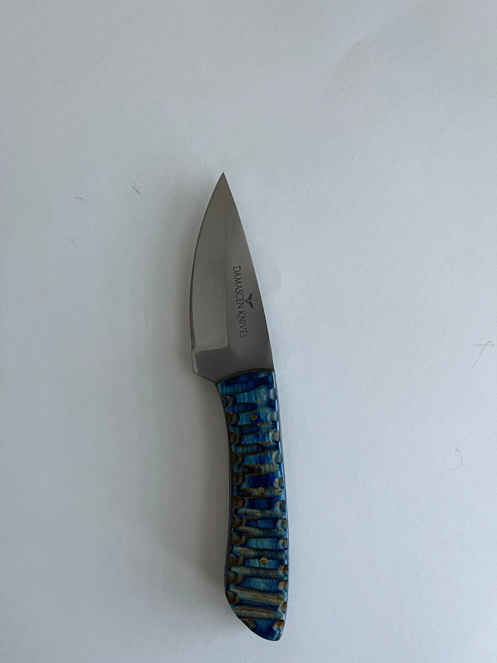 Polished blue wooden handle of Blue Phantom hunting knife offering ergonomic grip and elegant finish.