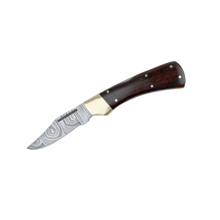 Side view of Damascus folding knife partially inserted into its brown leather sheath showing brass bolster and black wood handle.