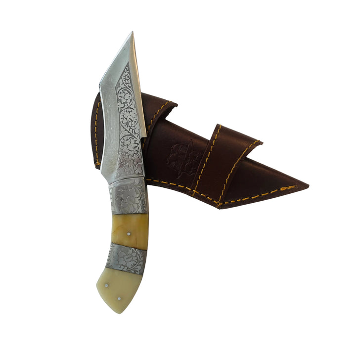 Top angle view of Damascus knife with bone handle and stitched leather sheath