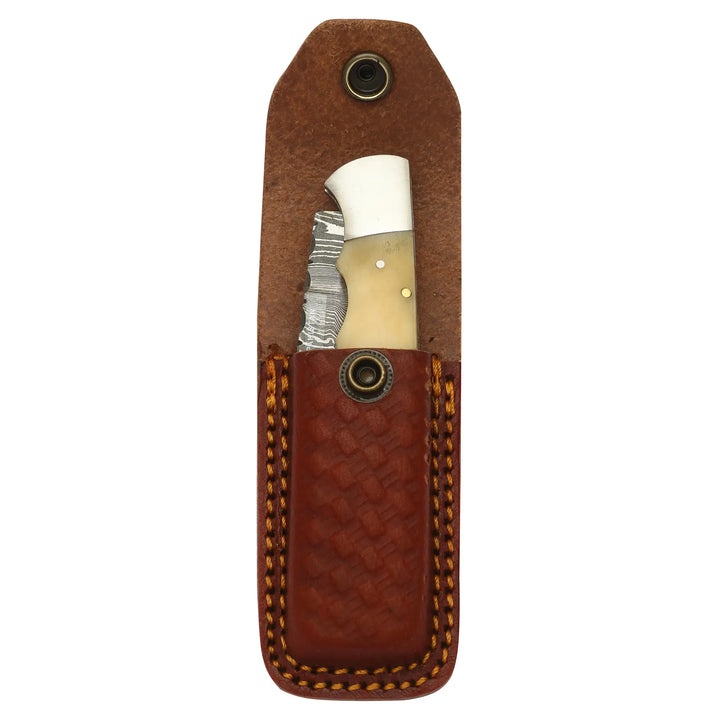 Handmade Damascus pocket knife stored in brown leather sheath
