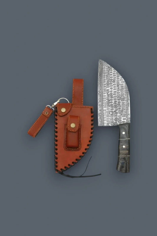 Vertical flat lay of a textured Damascus meat cleaver knife with a dark Pakkawood handle, displayed side-by-side with its intricate laced leather sheath.