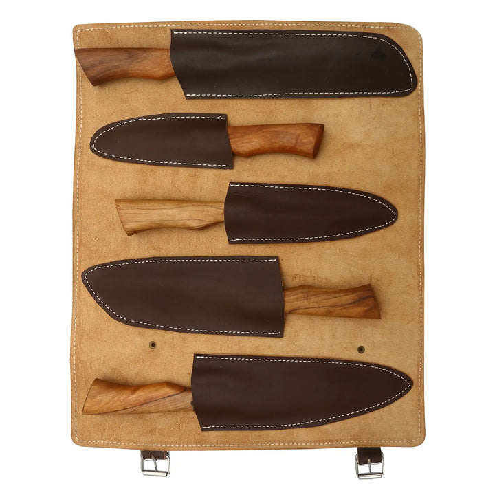 Five hand-forged Damascus steel chef knives displayed on wooden board with leather sheaths.