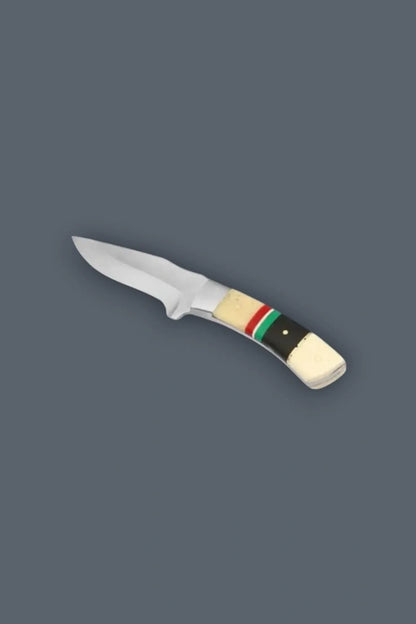 Diagonal flat lay displaying the reverse side of the stainless steel fixed blade hunting knife, showcasing the symmetrical multi-colored bone handle and securing pins.