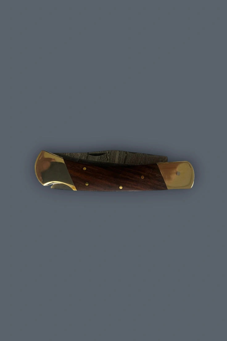 Horizontal spine profile of the closed Old World Edge knife showing the wood handle and brass bolsters.