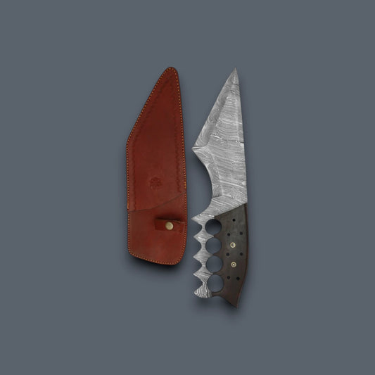 A fixed-blade knife with a patterned silver blade, a dark textured handle, and a brown leather sheath, displayed on a solid dark gray background.