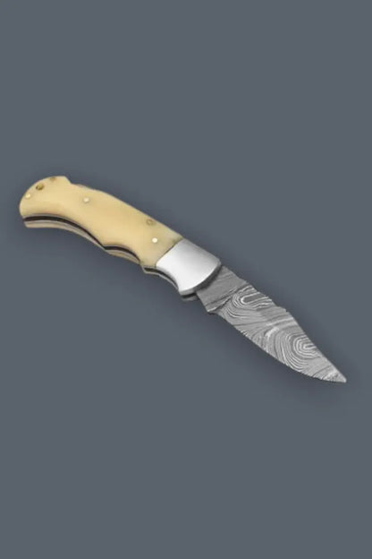 Opened heritage hunter lockback Damascus folding knife featuring a classic bone handle.
