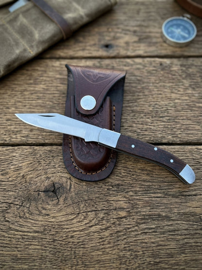 Old Southern style stainless steel pocket knife with plain dark Pakkawood handle and cowhide leather sheath