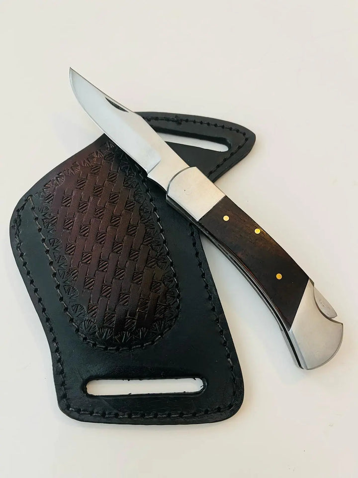 Puma Classic folding knife partially inserted into leather belt sheath