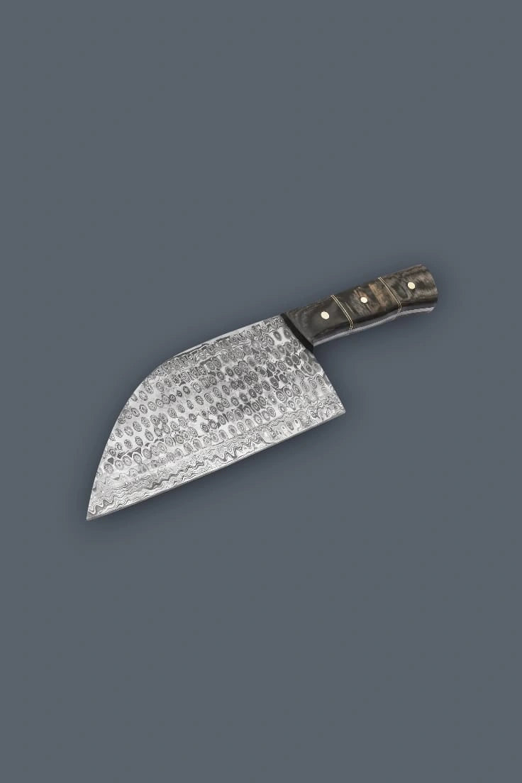 Upward diagonal flat lay displaying the reverse side of the Damascus meat cleaver, featuring the sweeping curved cutting edge and the dark Pakkawood handle grain.