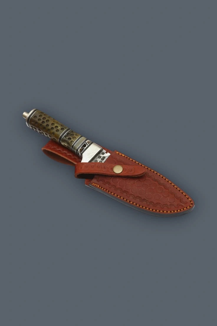 Vertical flat lay of the Damascen Knives fixed blade pointing upward, showcasing the spine jimping, single quillon guard, and textured cylindrical bone handle.