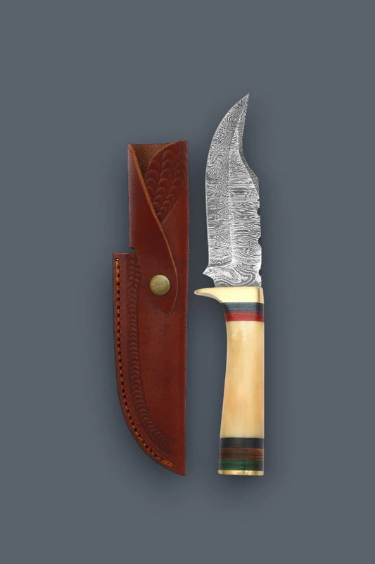 Vertical flat lay of a Damascen Knives fixed blade hunting knife with a banded bone handle, displayed alongside its stamped genuine leather sheath.